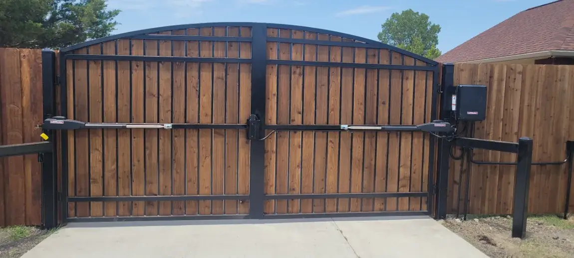Cedar double gate in a steel frame on a Corsicana, Texas property
