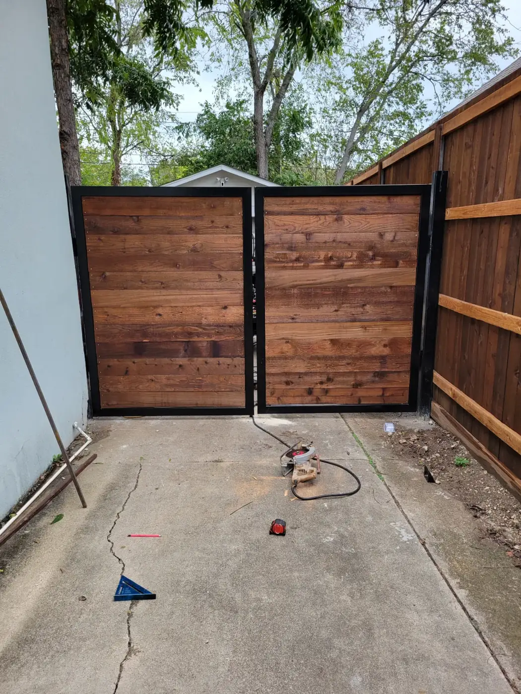 Cedar gate in steel frame, install day by Aesthetic Gates & Fence in Navarro County, Texas