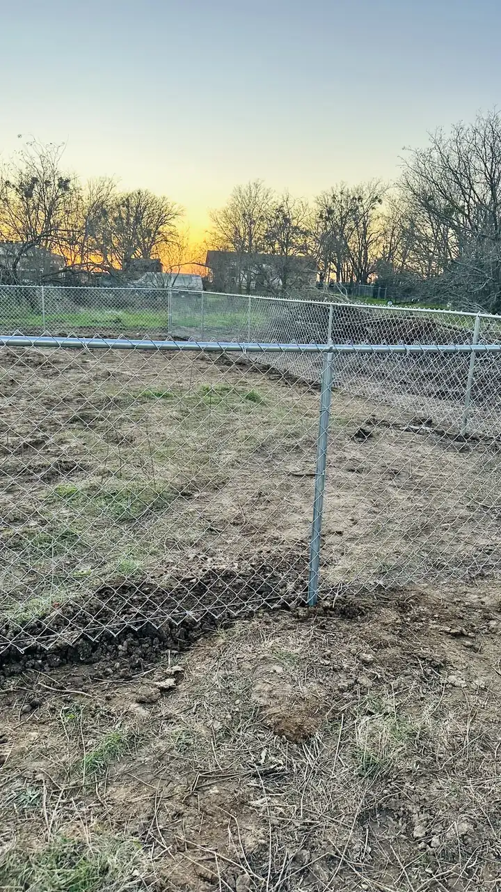 Chain link going in at sunset by Aesthetic Gates & Fence in Navarro County, Texas