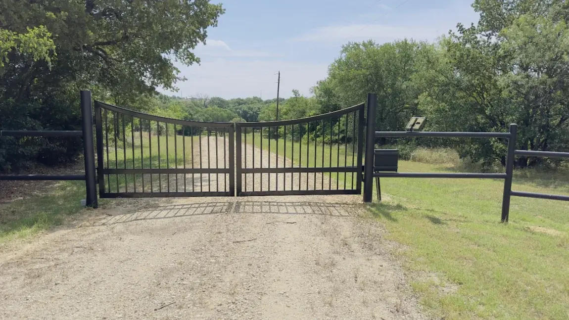Iron entry gate on a pasture drive by Aesthetic Gates & Fence in Navarro County, Texas