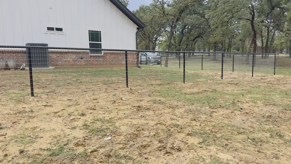 Iron fence at a brick home by Aesthetic Gates & Fence in Navarro County, Texas