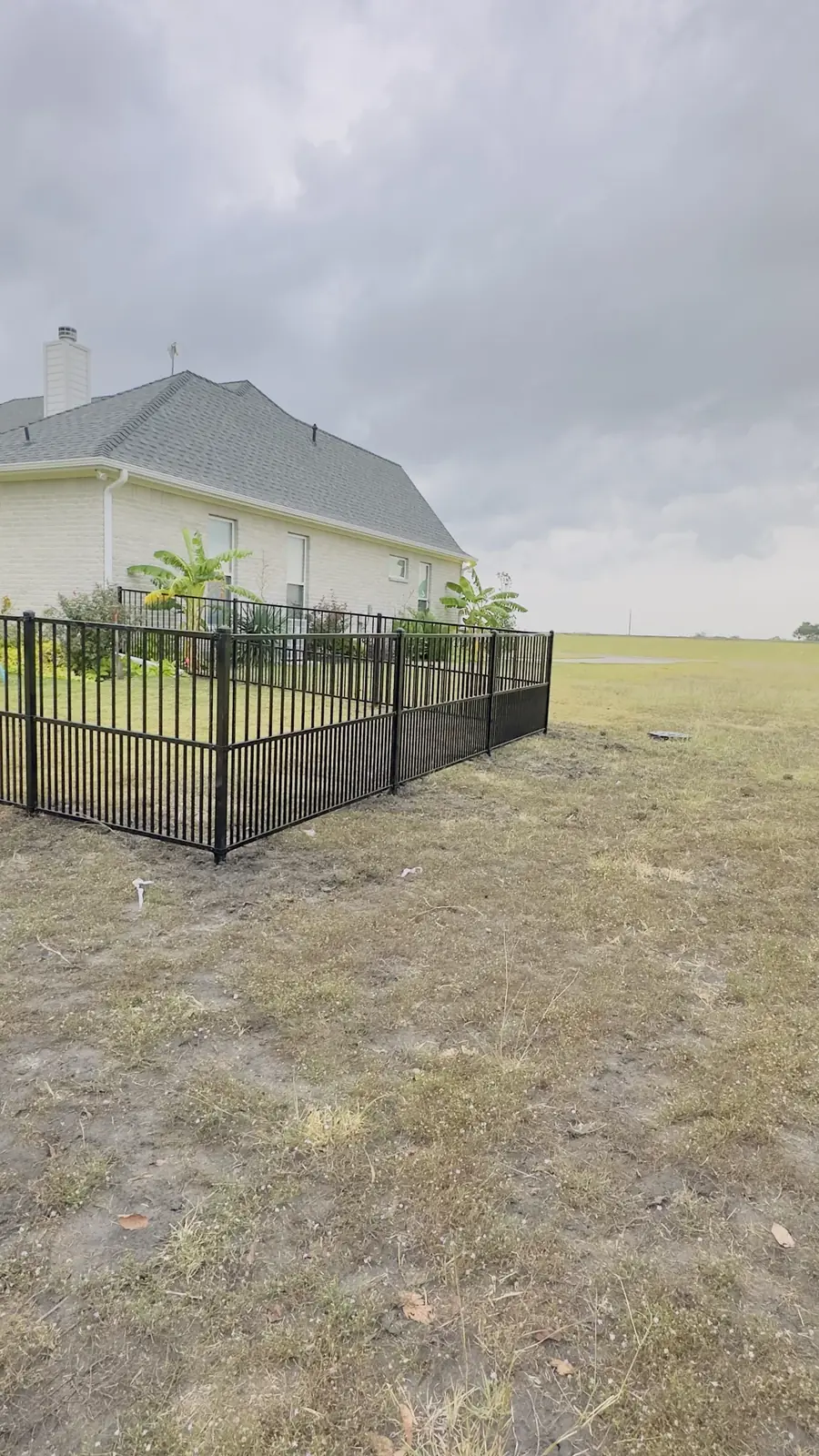 Iron fence around a house corner by Aesthetic Gates & Fence in Navarro County, Texas