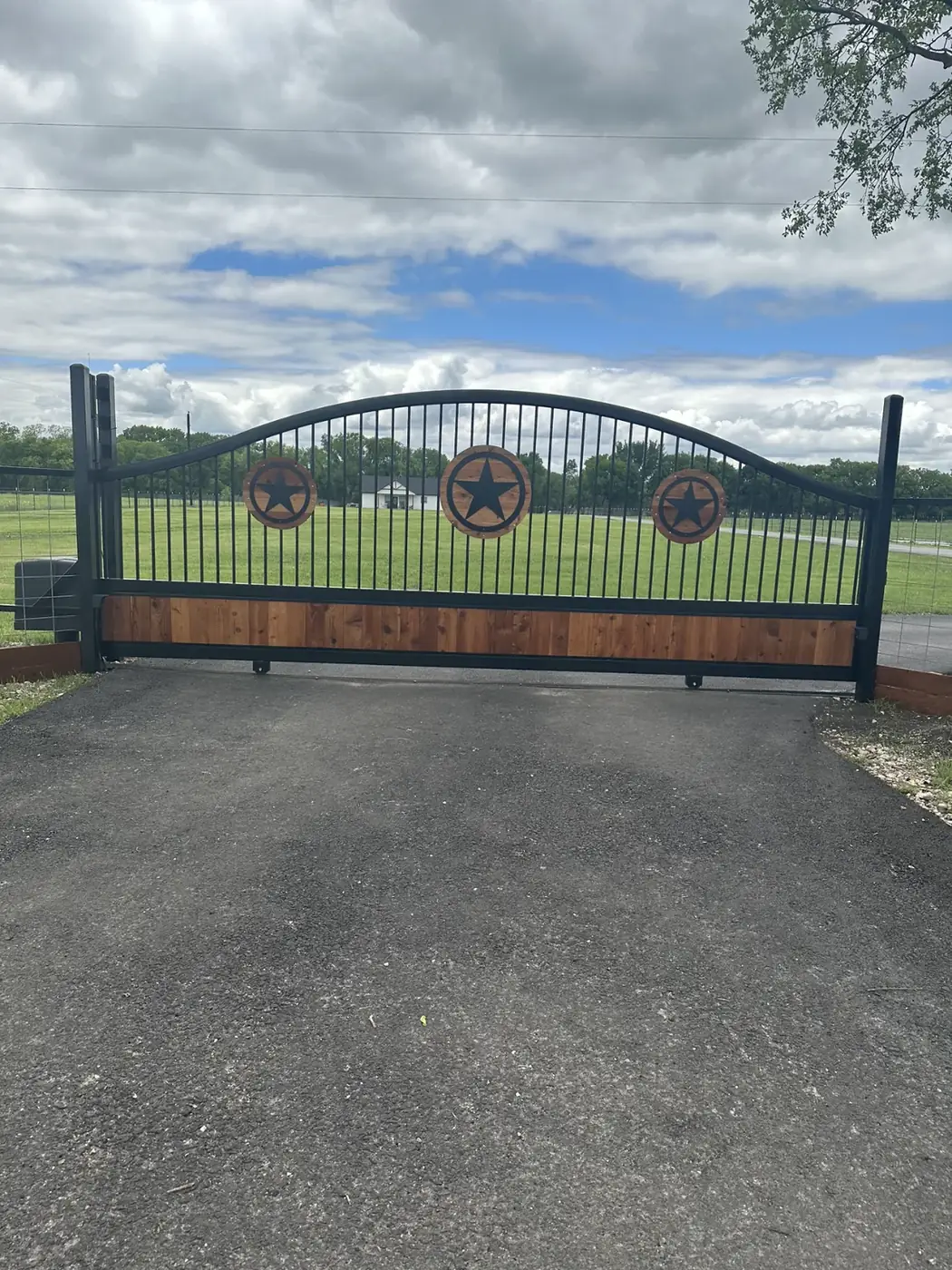 Iron gate with Texas stars and cedar by Aesthetic Gates & Fence in Navarro County, Texas