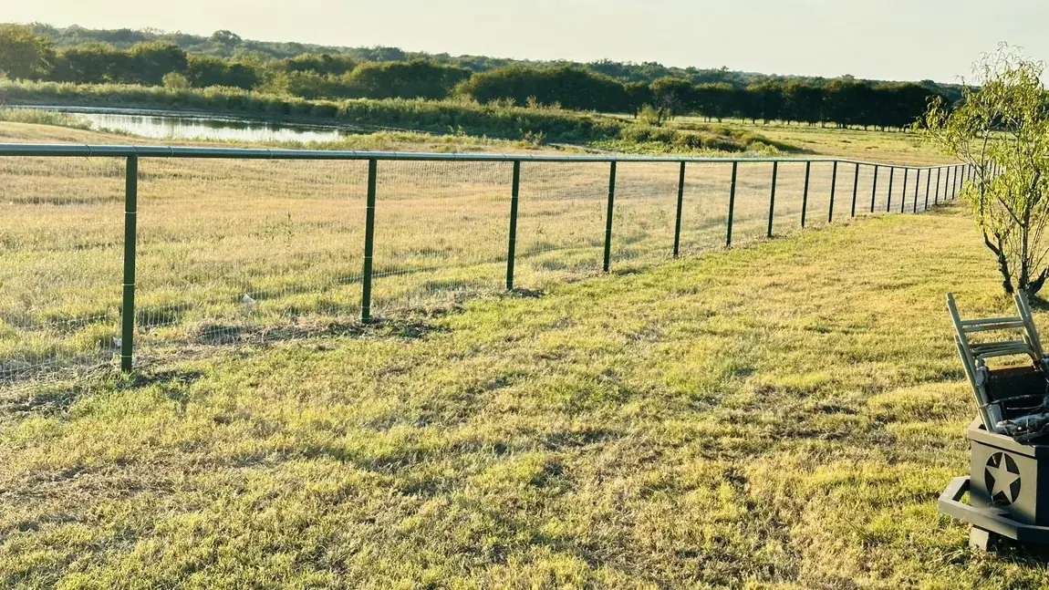Pipe fence on the pasture line by Aesthetic Gates & Fence in Navarro County, Texas