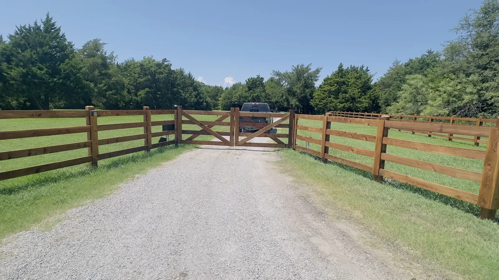 Cedar driveway gate in a steel frame built by Aesthetic Gates & Fence in Navarro County, Texas
