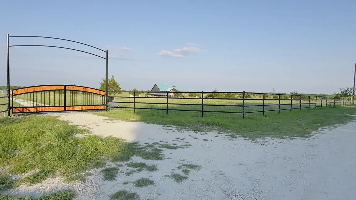 Ranch gate with matching rail fence by Aesthetic Gates & Fence in Navarro County, Texas