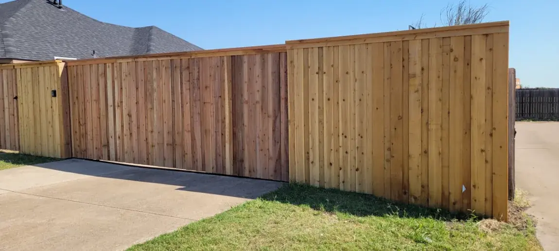 Wood fence along a driveway by Aesthetic Gates & Fence in Navarro County, Texas