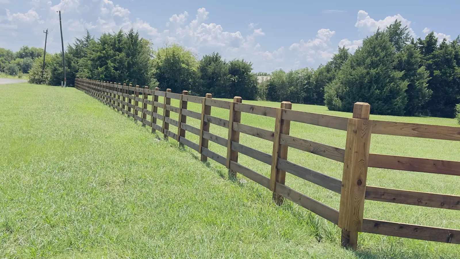 Wood rail fence down the line by Aesthetic Gates & Fence in Navarro County, Texas